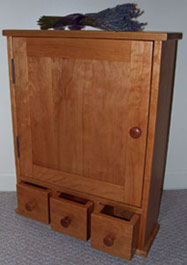cherry medicine cabinet with apothecary styled drawers